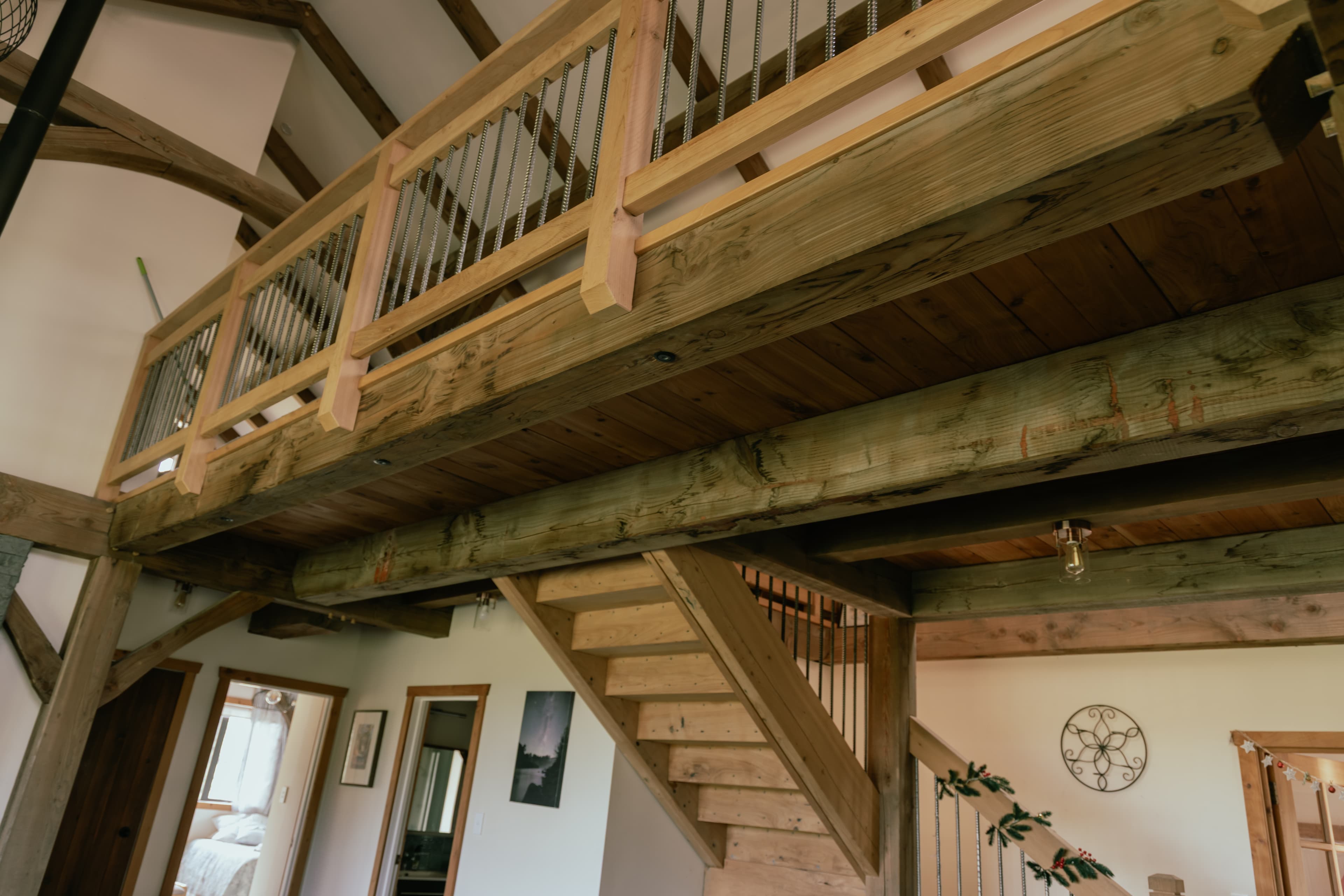 Reclaimed timber stairwell from antique U.S. barn. New Zealand grown Macrocarpa treads and hand forged metal balustrades