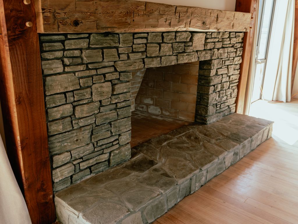 Large stone open fireplace in barn home